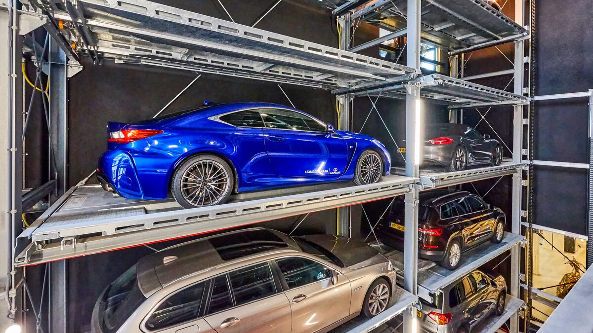The car is parked on a parking pallet in a multi-storey car park system
