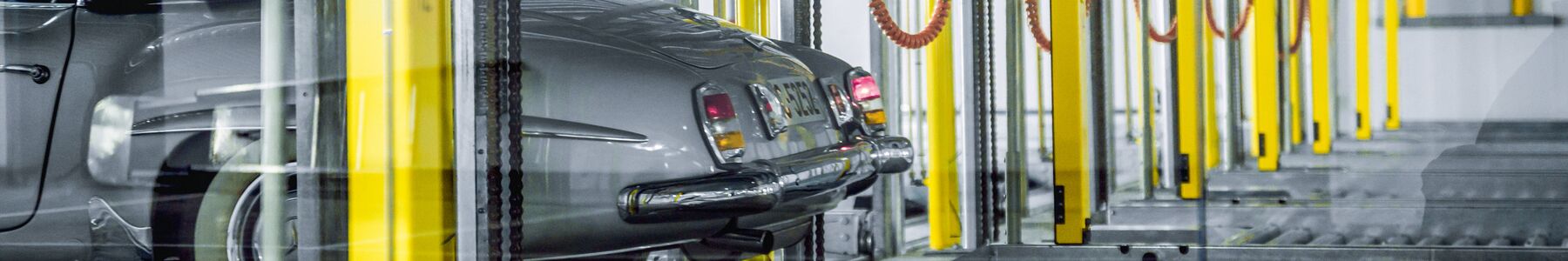 A car drives through a parking system equipped with electric charging points