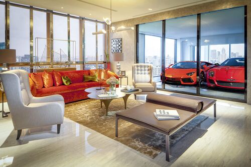 The living room of a flat, with the cars parked in the sky garage