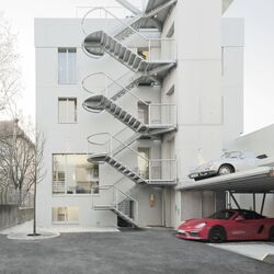 A building on Olgastraße with a car parking system built in front of it